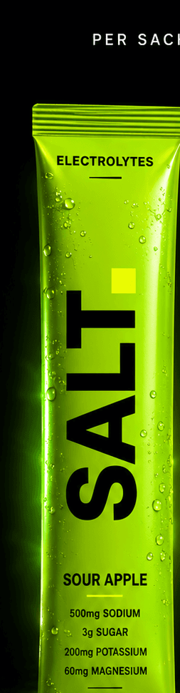 SALT Sour Apple sachet — vivid lime-green pack on a dark stage, 500mg sodium, 3g sugar per serve.